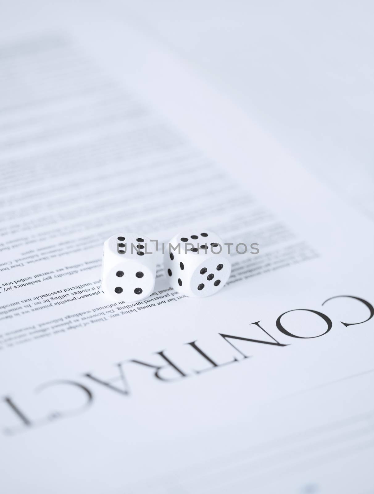 picture of contract paper with gambling dices