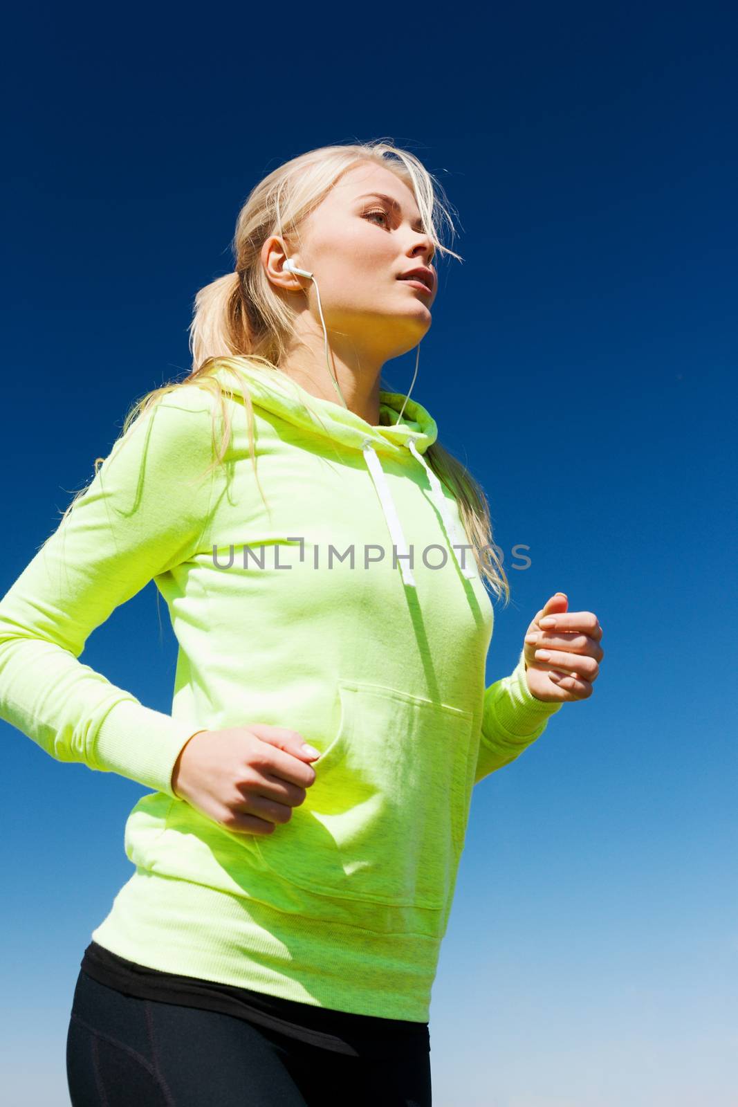 woman doing running outdoors by dolgachov