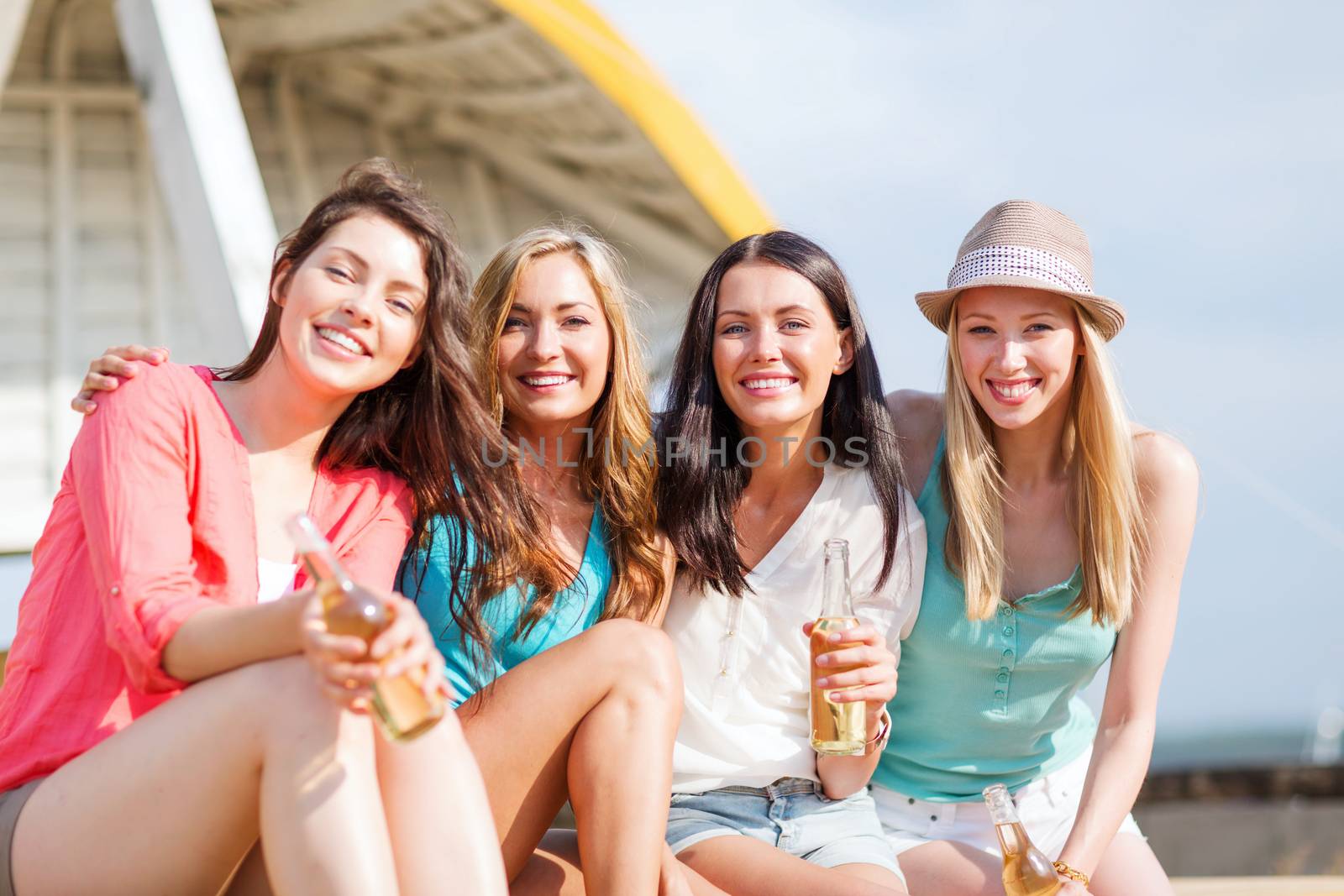 girls with drinks on the beach by dolgachov