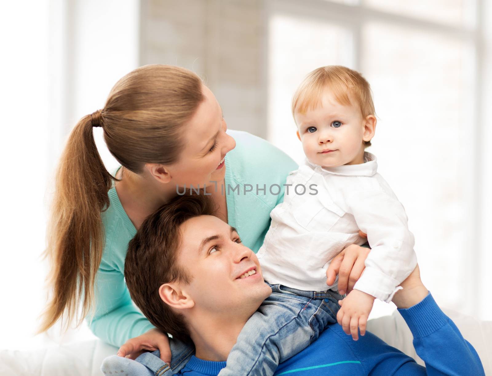 happy parents playing with adorable baby by dolgachov