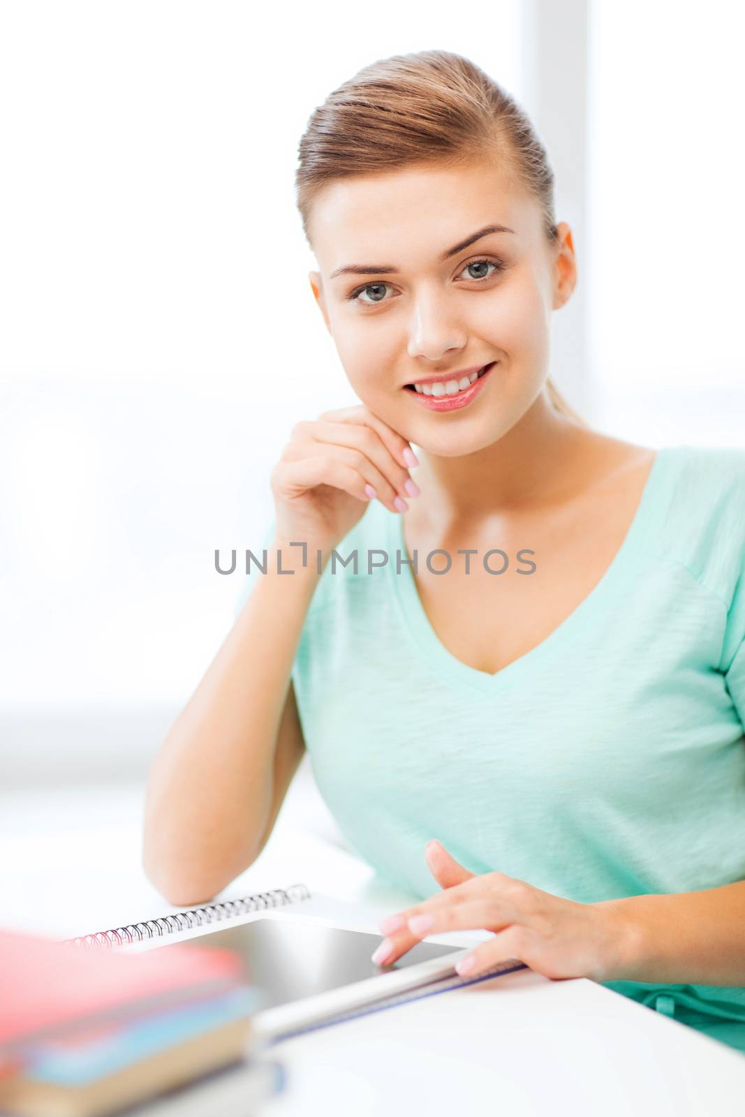 smiling student girl with tablet pc by dolgachov