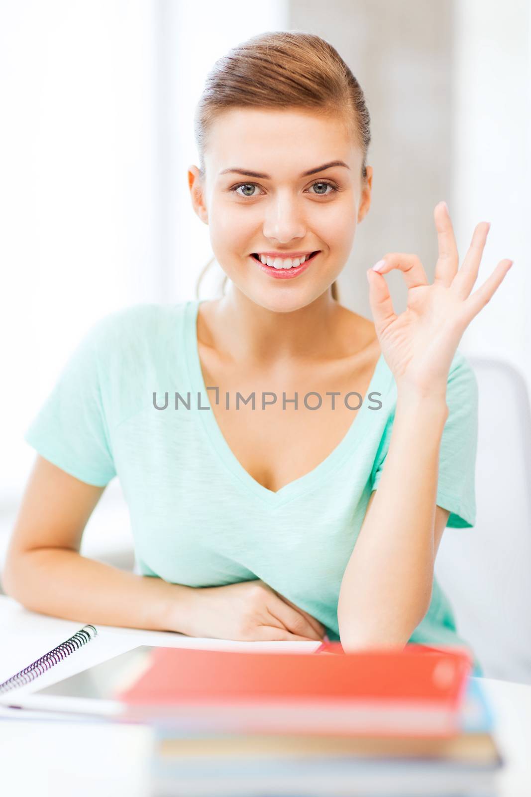 smiling student girl with tablet pc by dolgachov