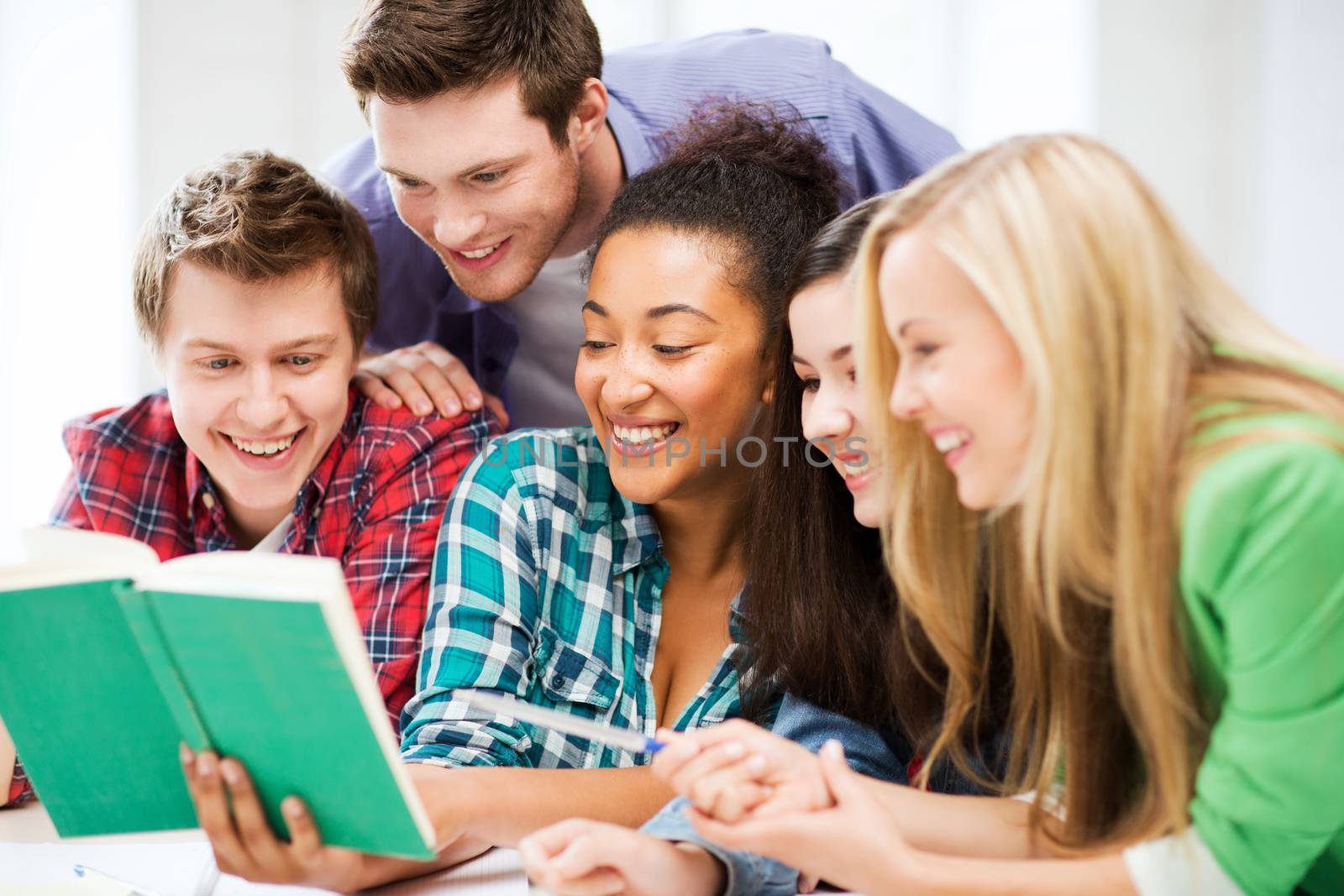 education concept - group of students reading book at school