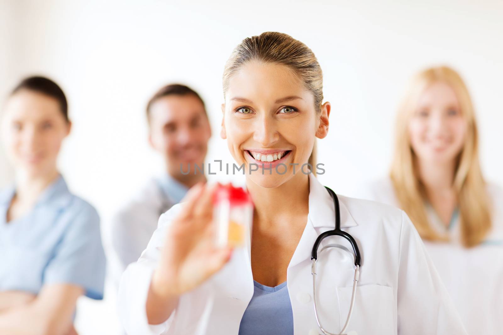 female doctor with jar of capsules by dolgachov