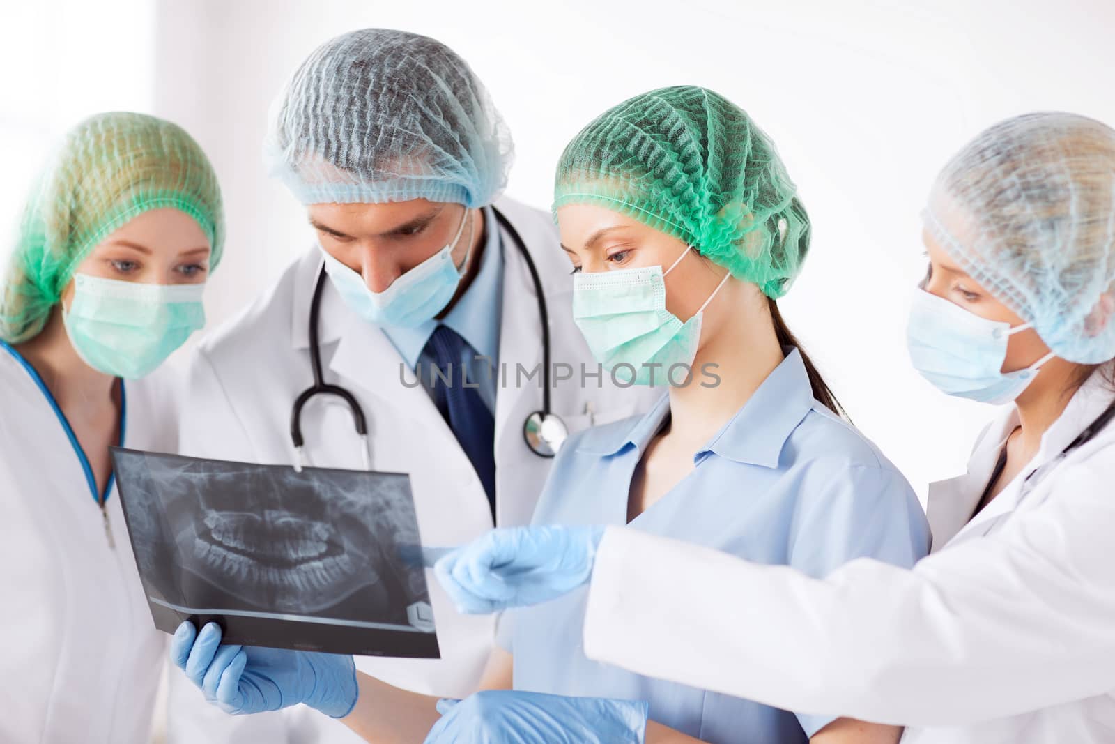 young group of doctors looking at x-ray by dolgachov