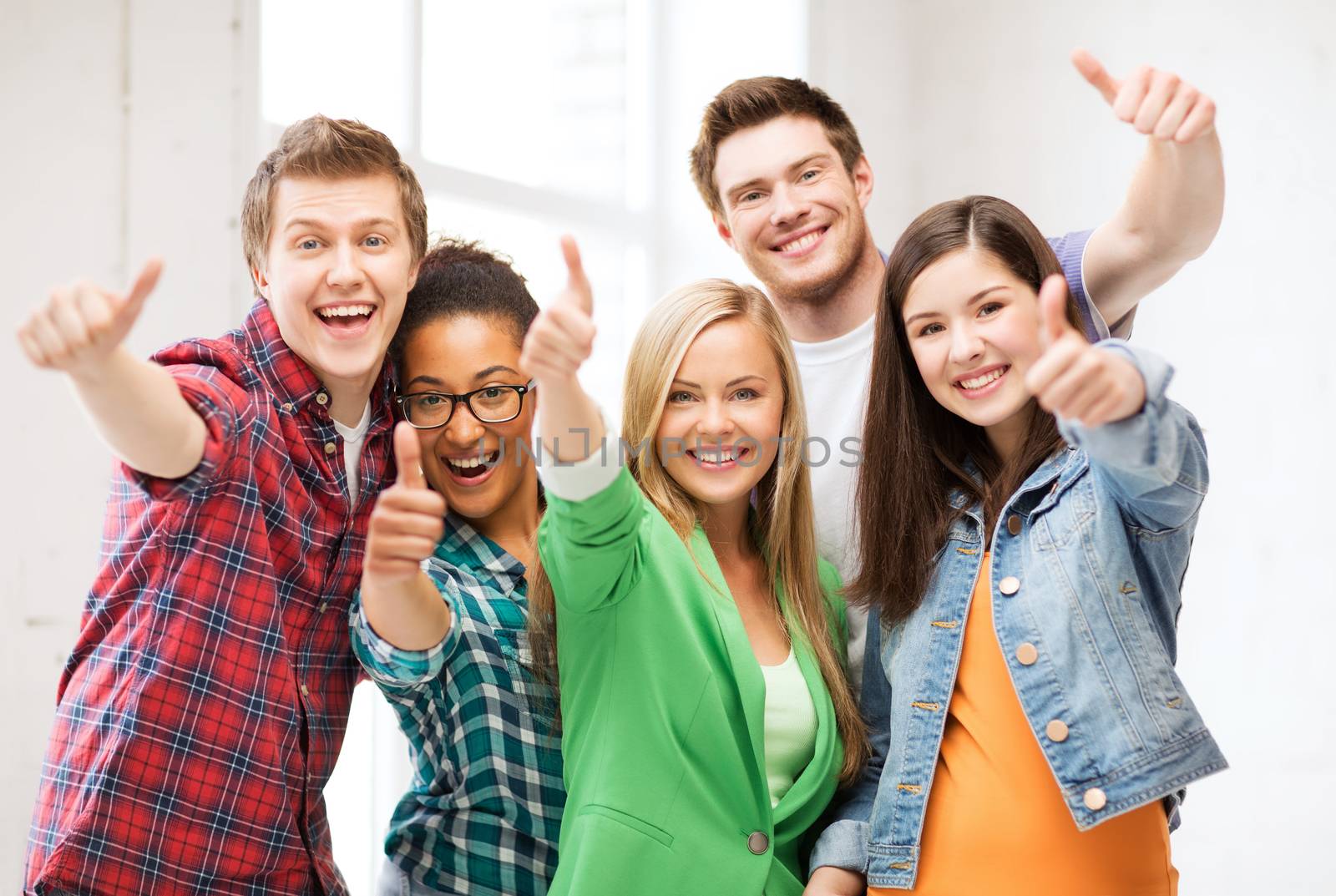 students showing thumbs up at school by dolgachov