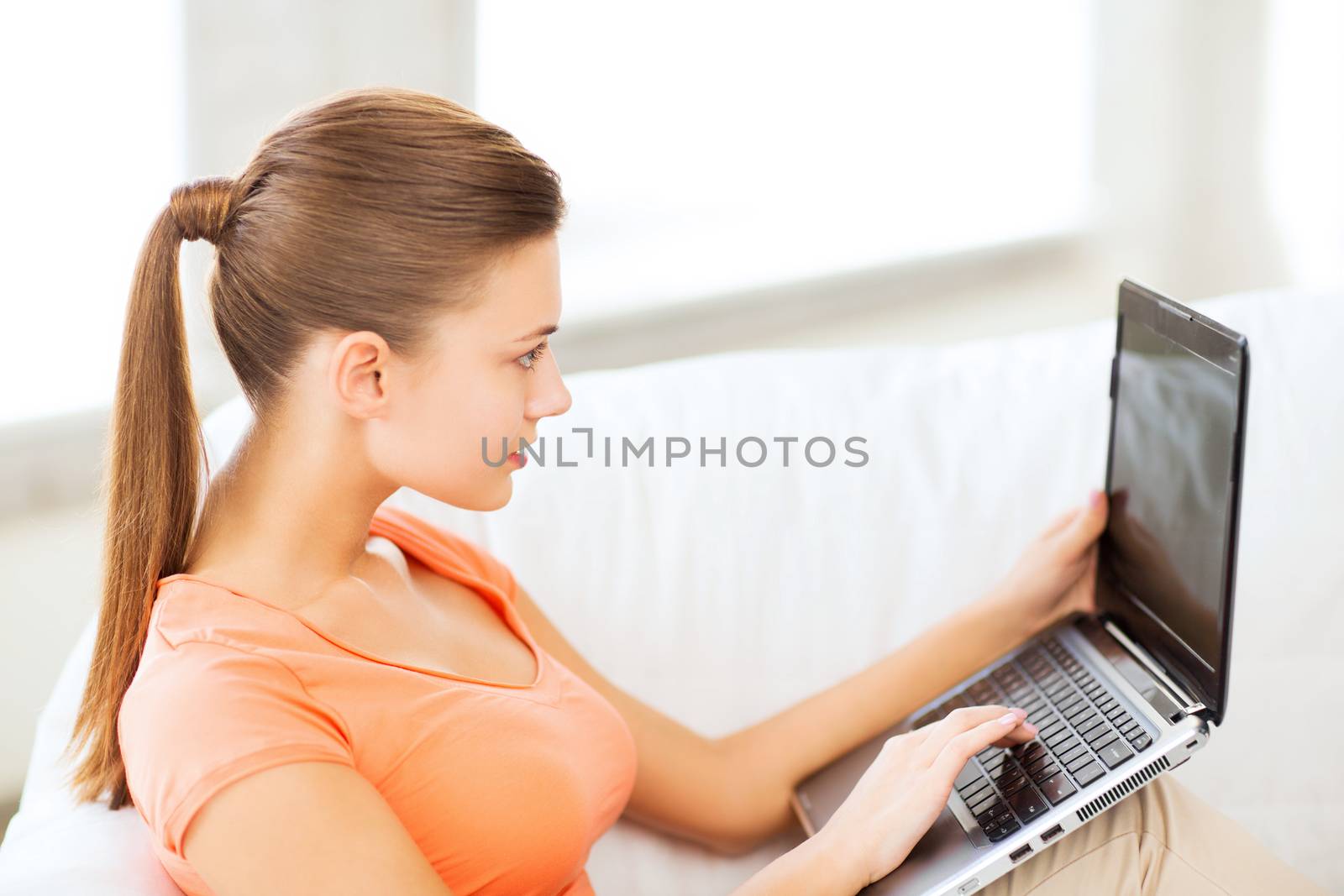 woman using laptop at home by dolgachov