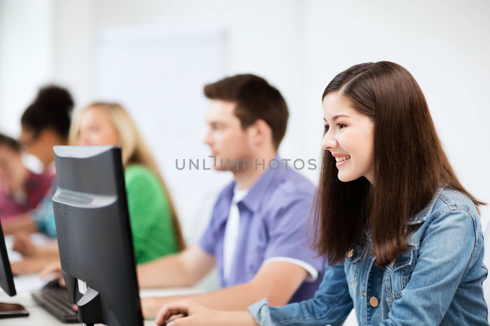 students with computers studying at school by dolgachov