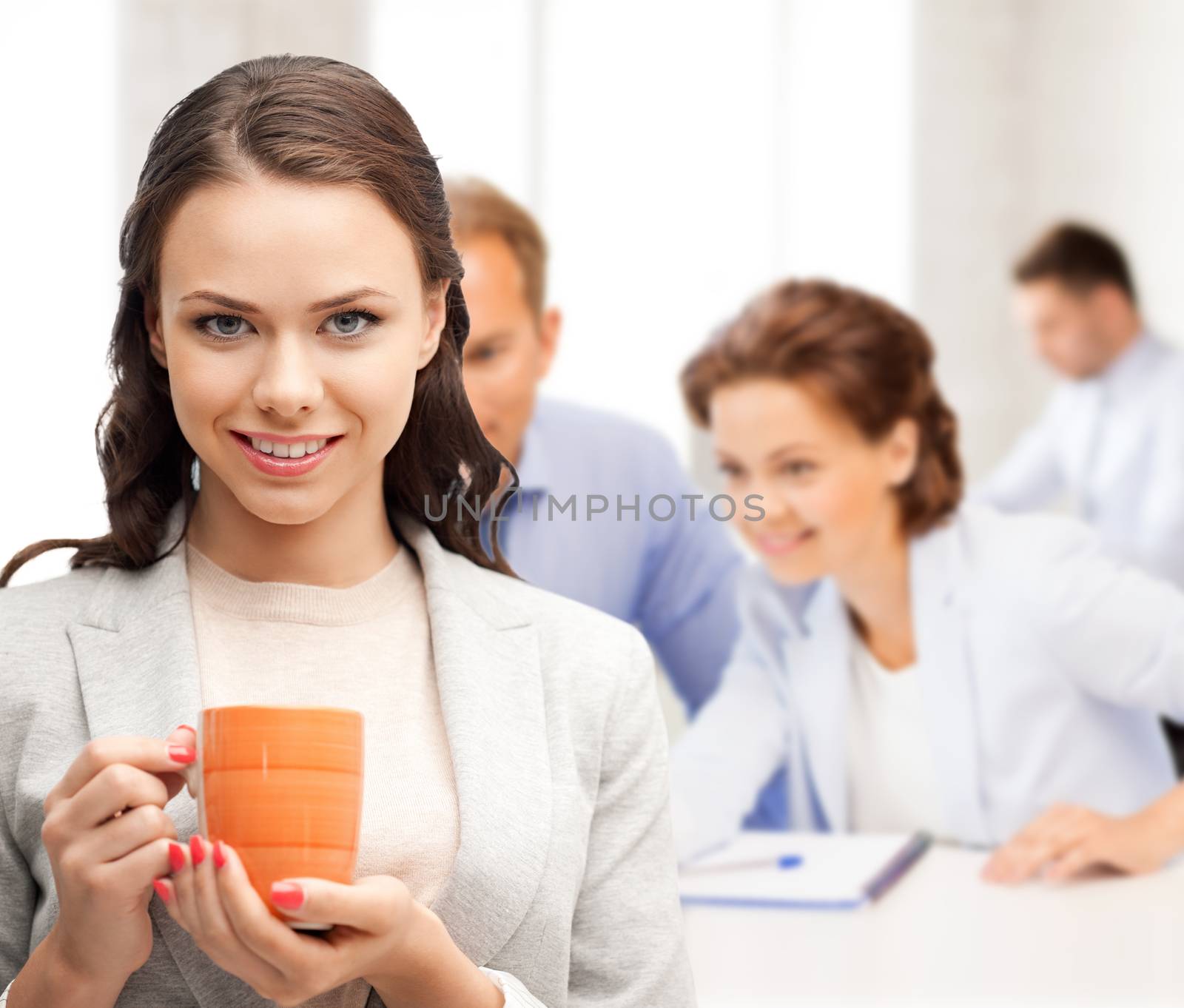 beautiful businesswoman with cup of coffee by dolgachov