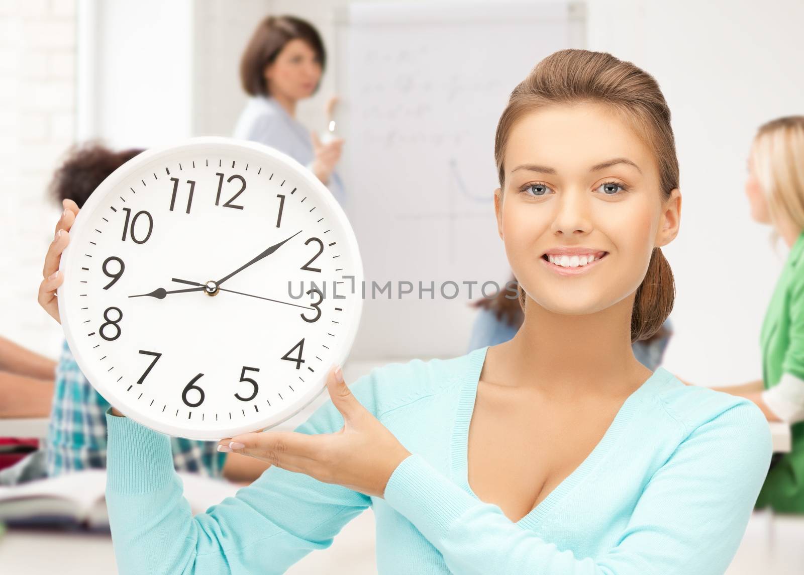 attractive student pointing at clock by dolgachov