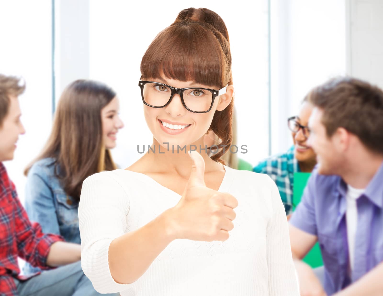 student showing thumbs up at school by dolgachov