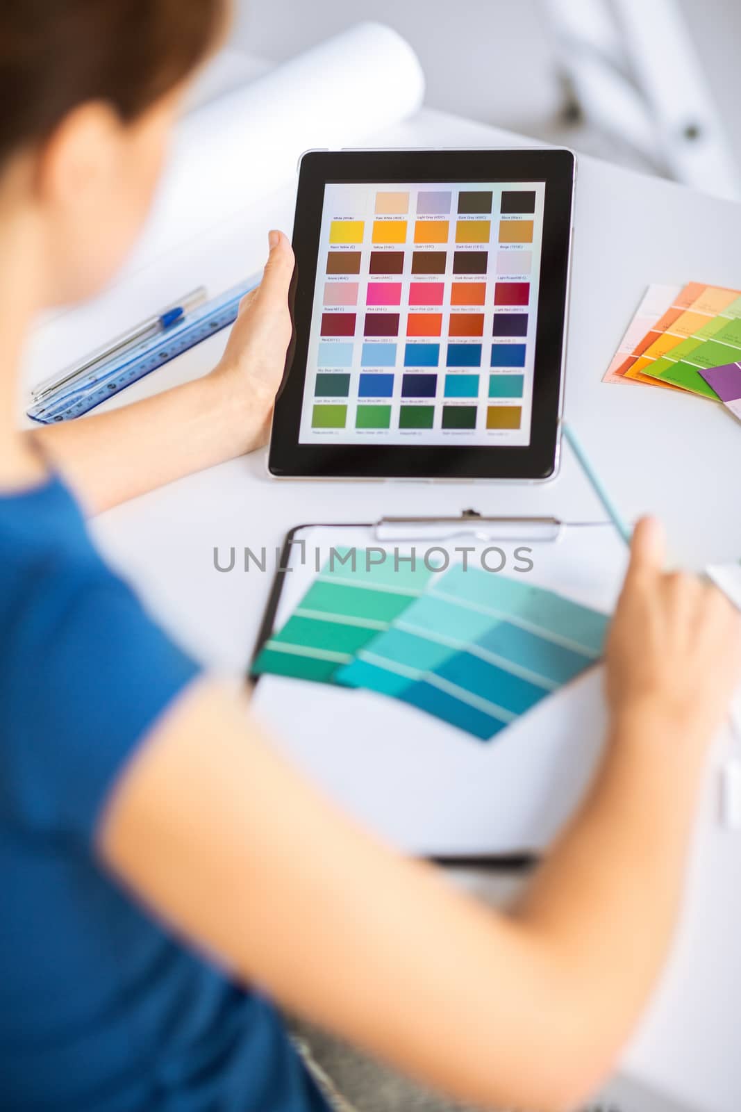 interior design, renovation and technology concept - woman working with color samples for selection