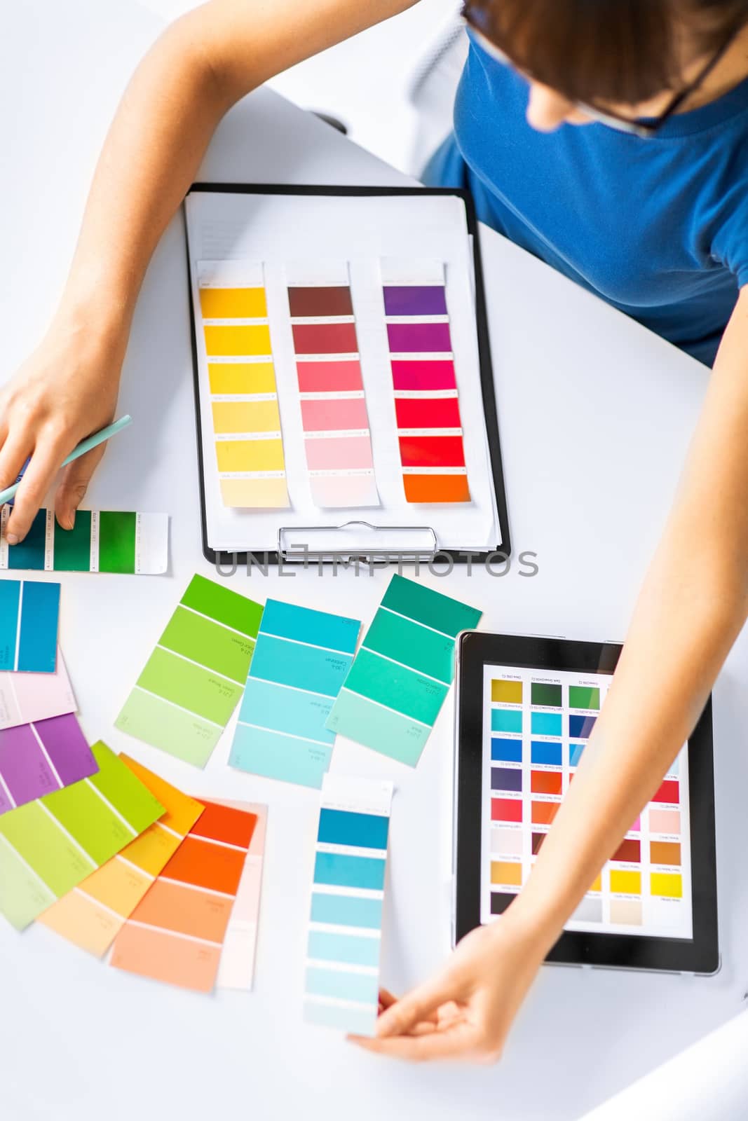 interior design, renovation and technology concept - woman working with color samples for selection