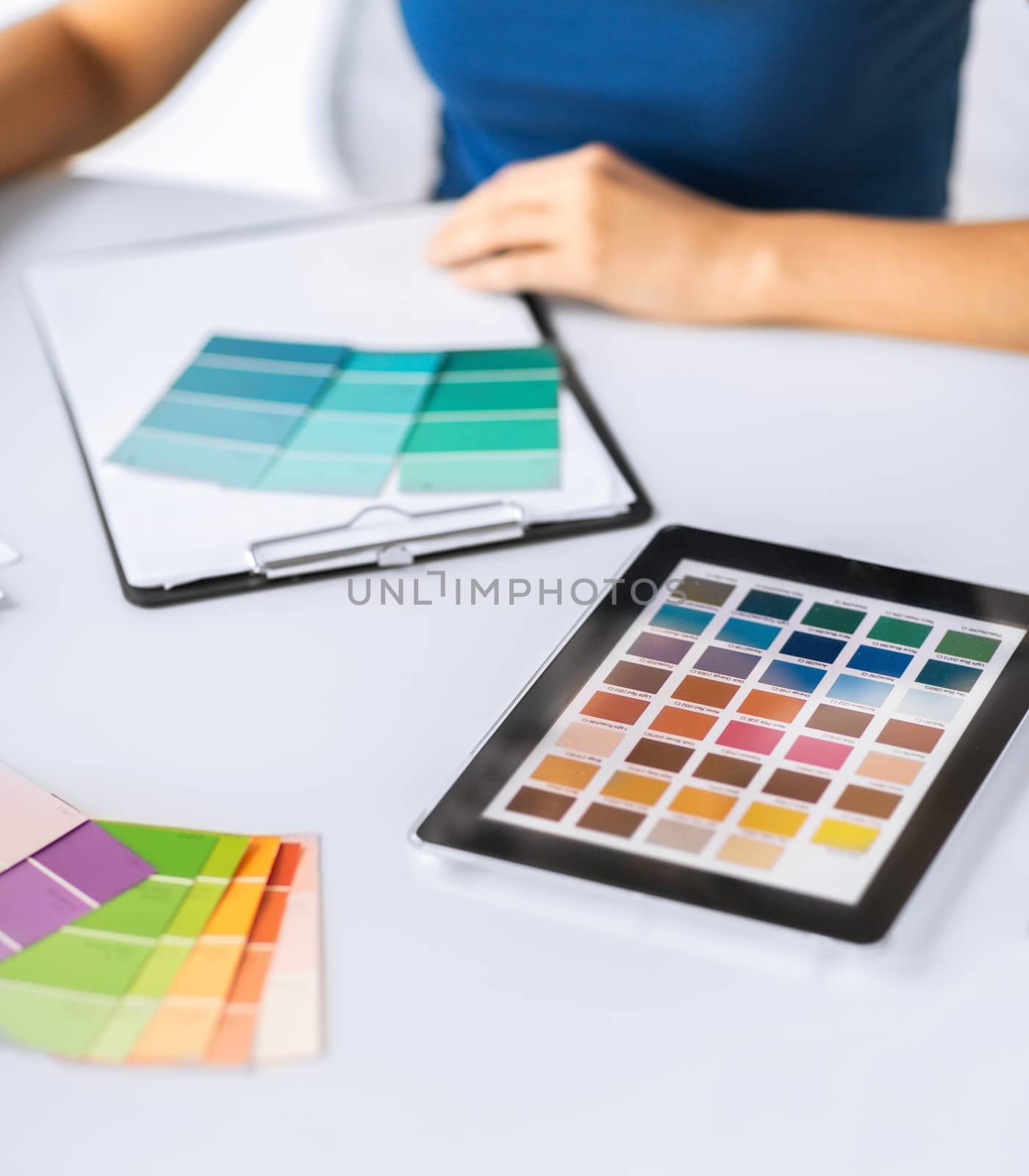 interior design, renovation and technology concept - woman working with color samples for selection