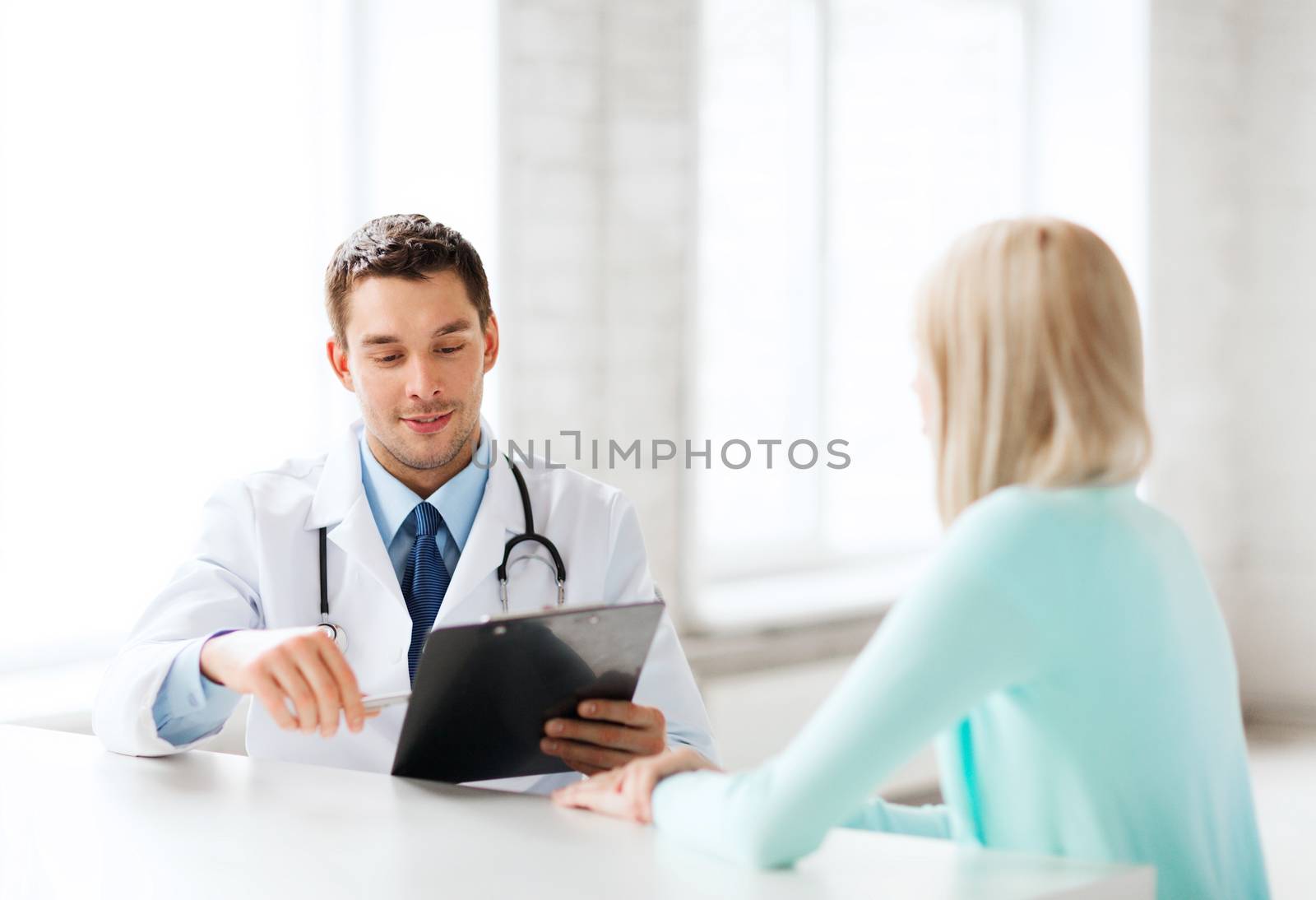 healthcare and medical concept - male doctor with patient in hospital