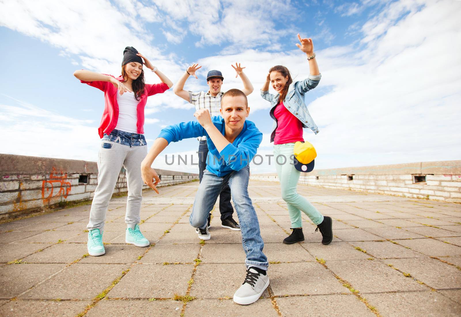 sport, dancing and urban culture concept - group of teenagers dancing