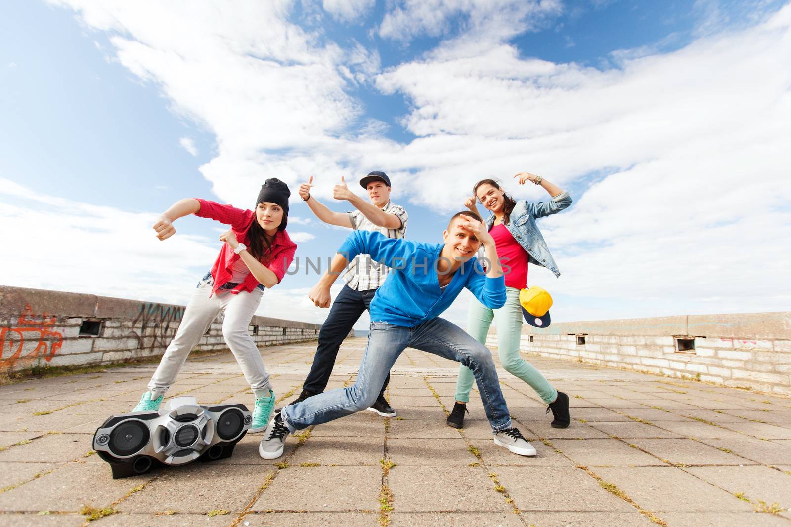 group of teenagers dancing by dolgachov