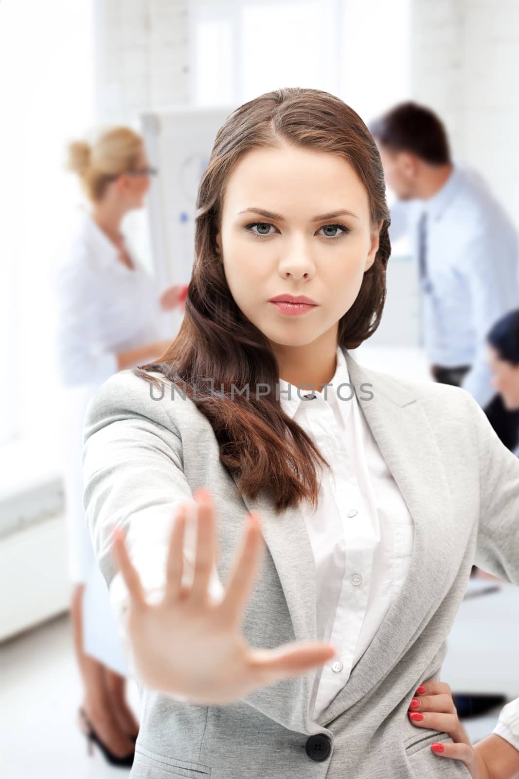 angry businesswoman showing stop gesture by dolgachov