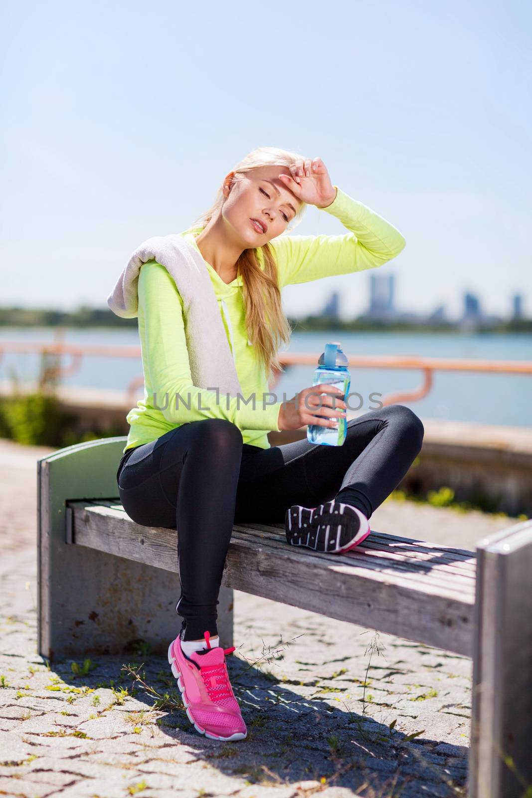 woman resting after doing sports outdoors by dolgachov