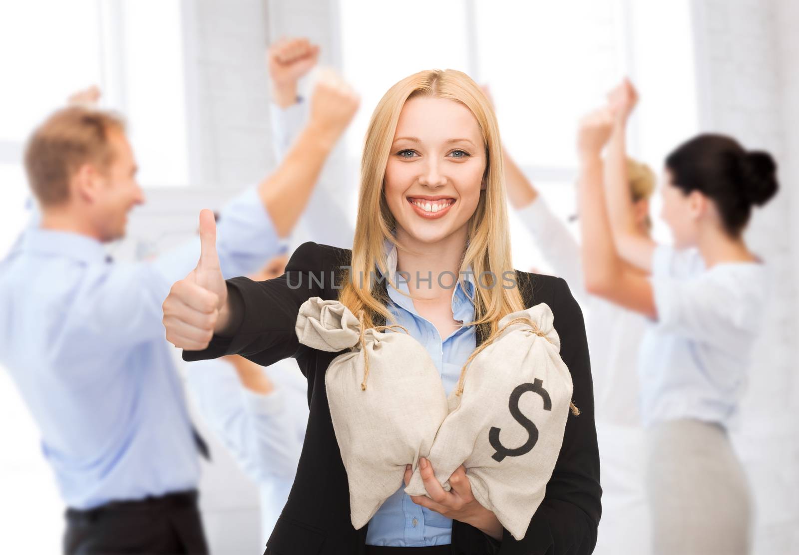 business and money concept - businesswoman with money bags showing thumbs up