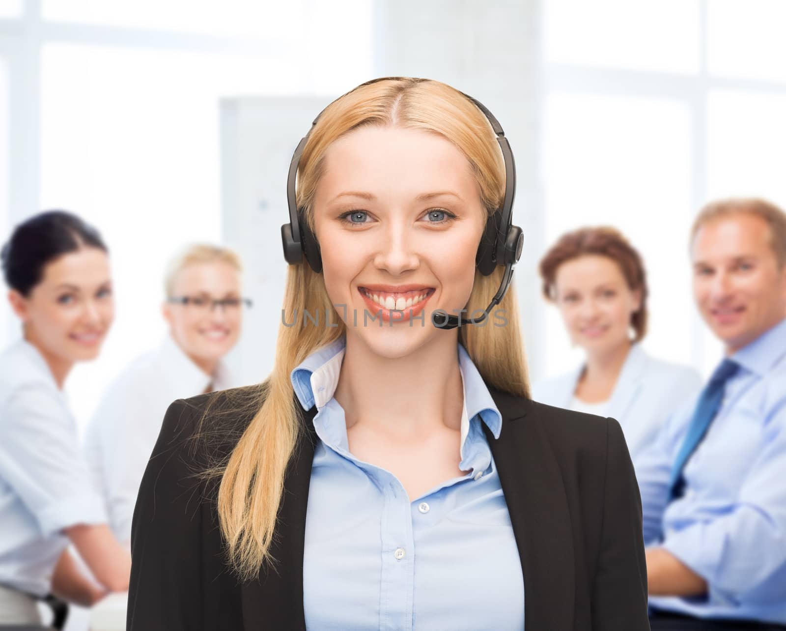helpline operator with headphones in call centre by dolgachov