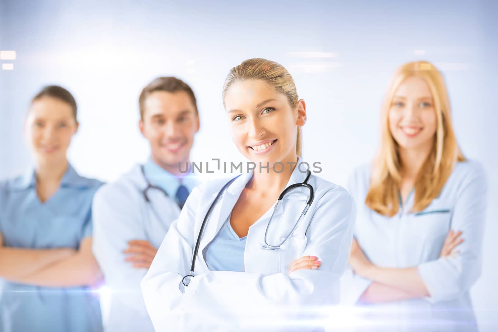 healthcare and medicine concept - female doctor in front of medical group