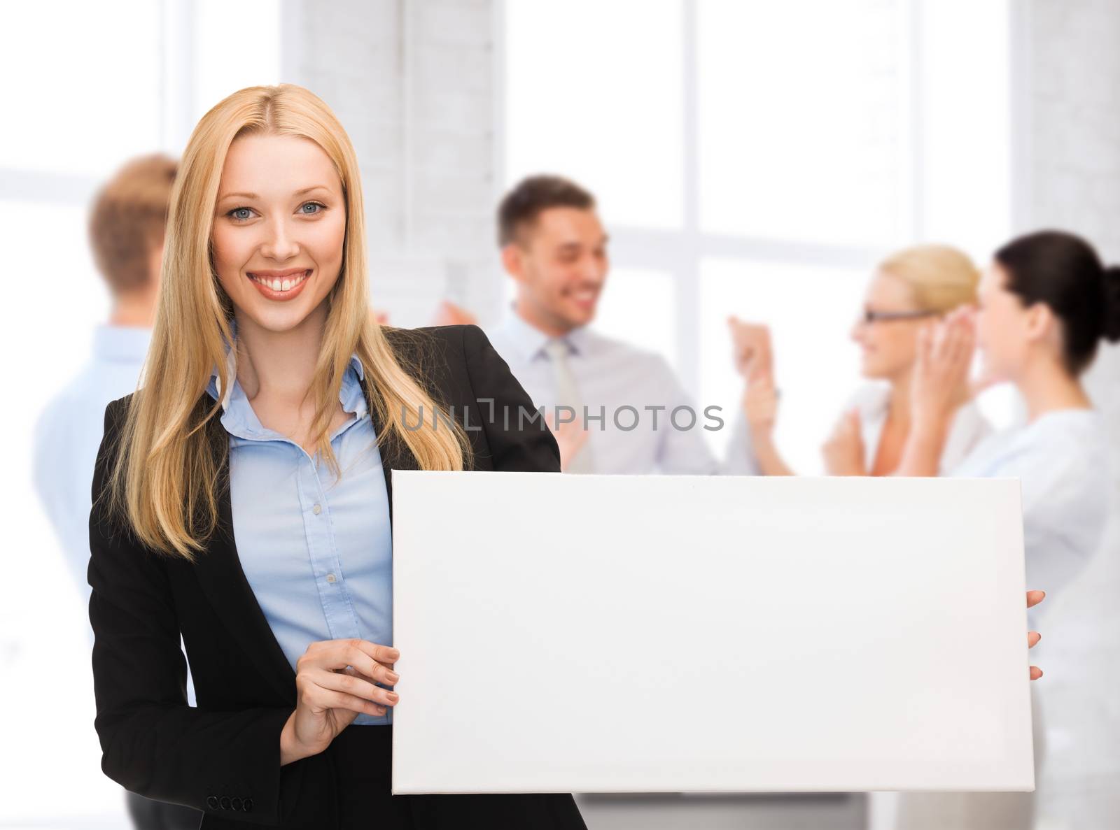 businesswoman with white blank board by dolgachov