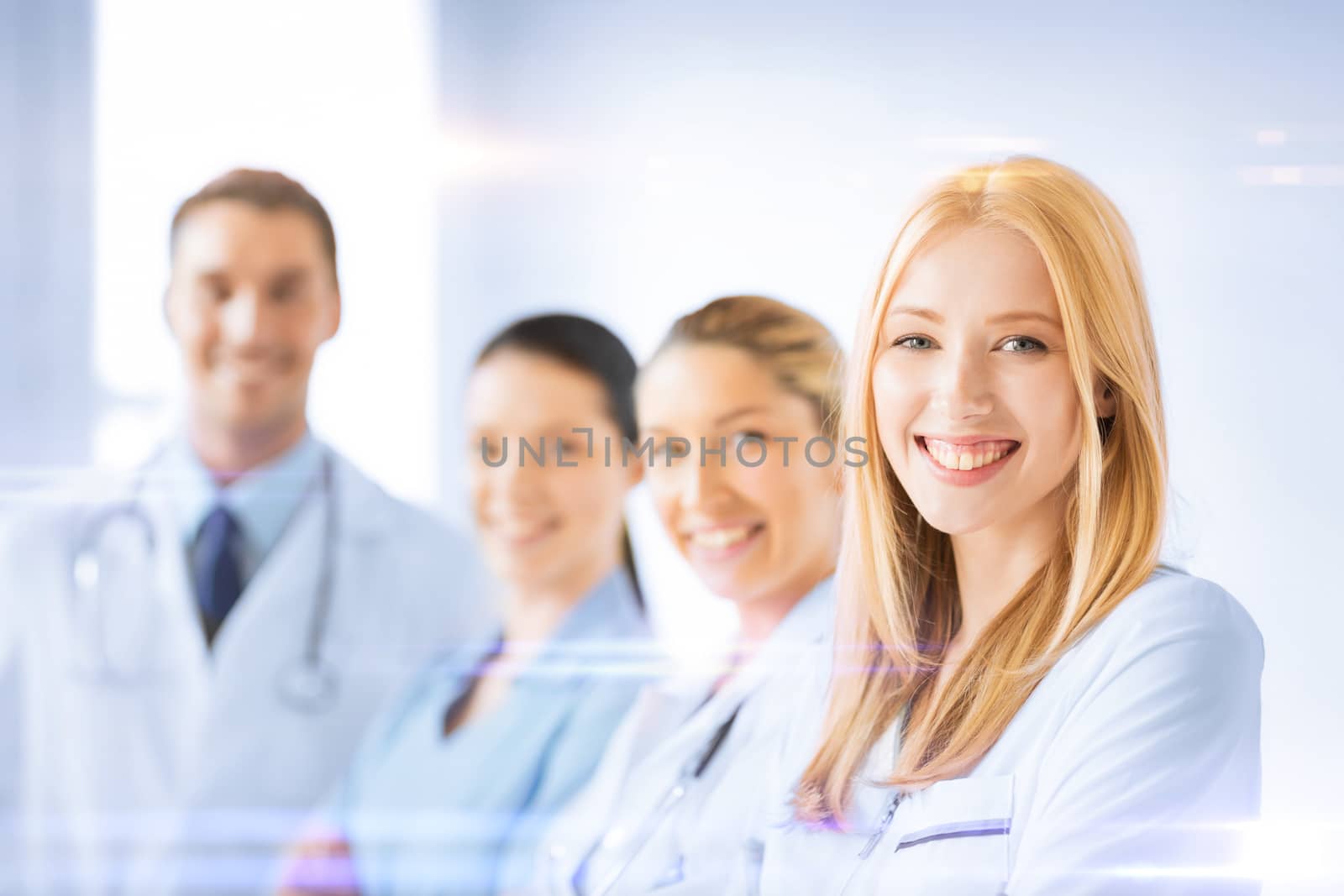 healthcare and medicine concept - female doctor in front of medical group