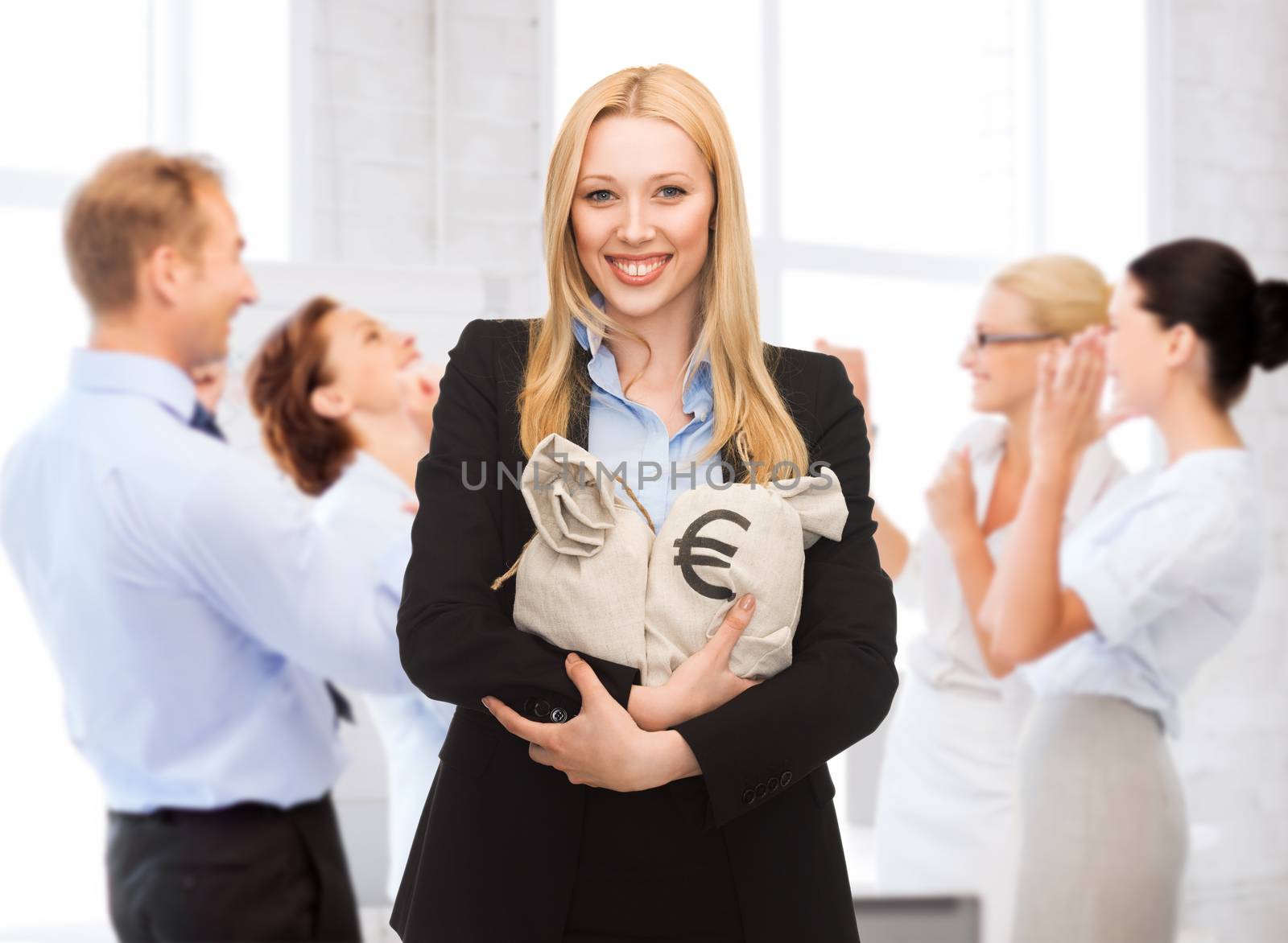 business and money - businesswoman holding money bags with euro