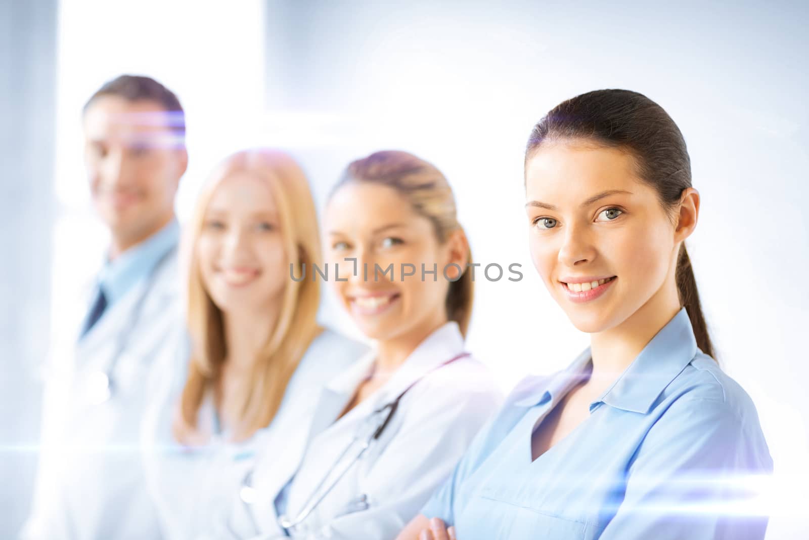 female doctor in front of medical group by dolgachov