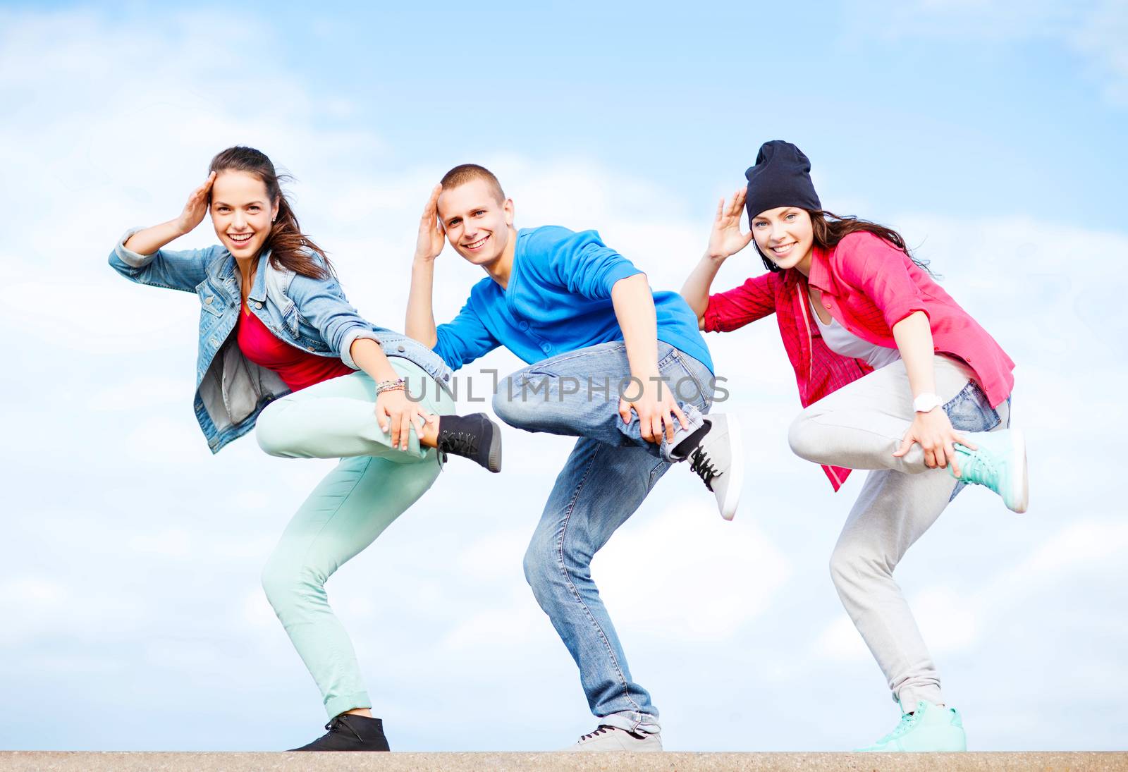 sport, dancing and urban culture concept - group of teenagers dancing