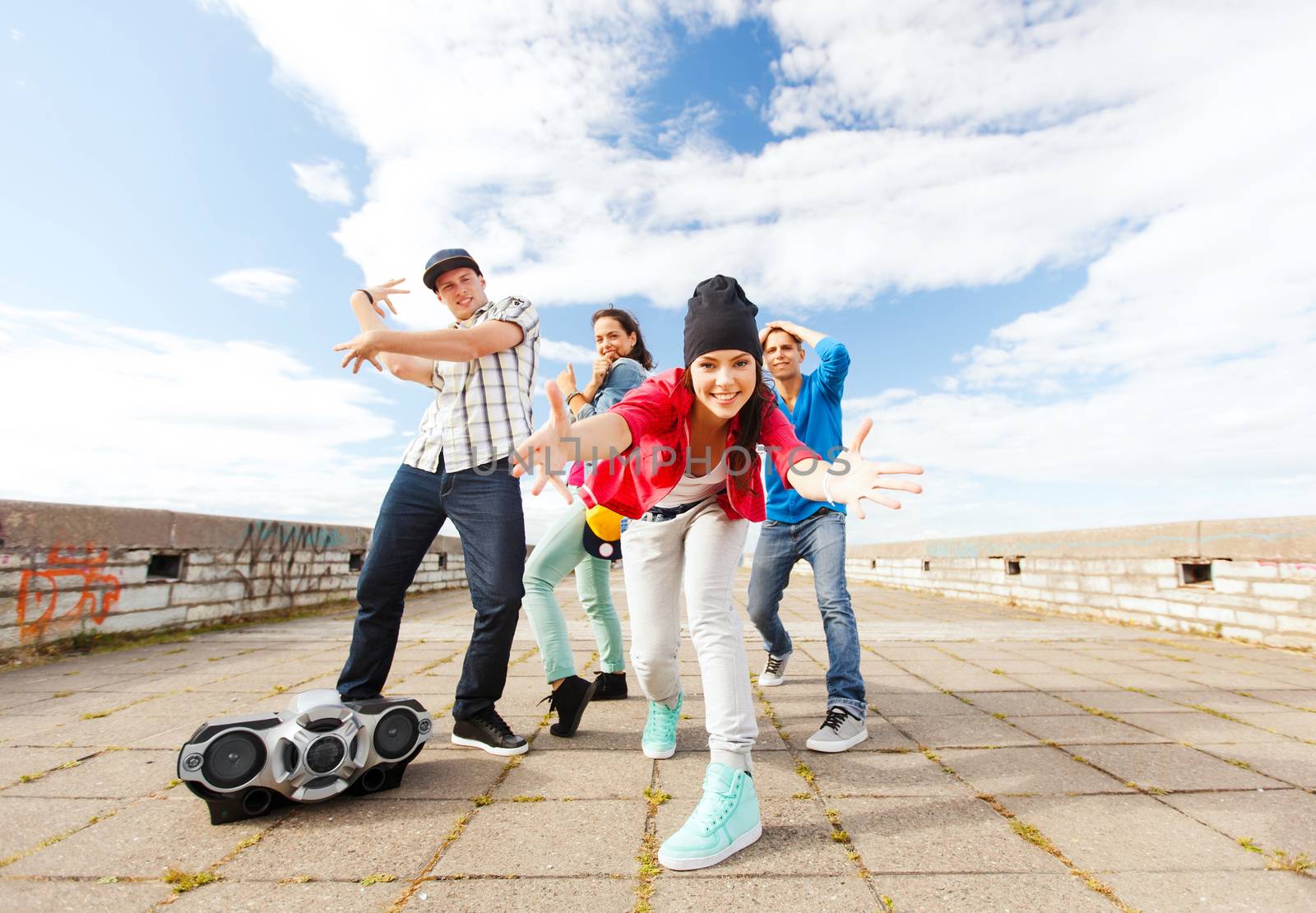 sport, dancing and urban culture concept - group of teenagers dancing