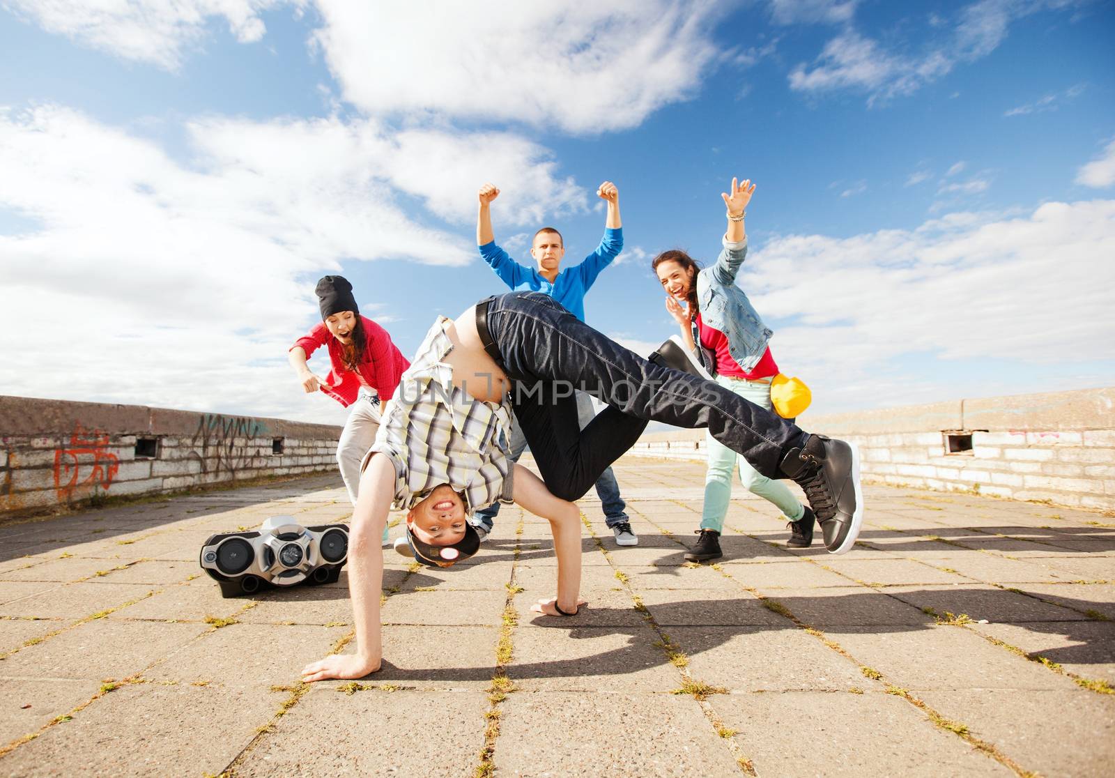 sport, dancing and urban culture concept - group of teenagers dancing