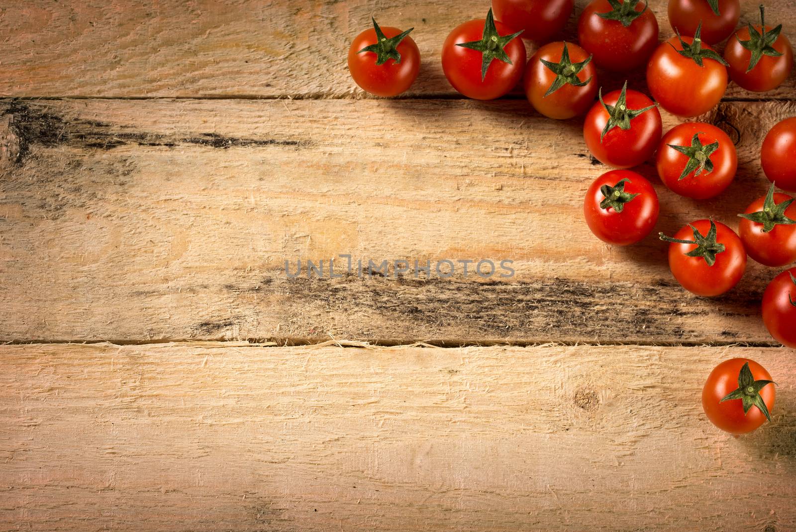 cherry tomatoes on wood background by dolgachov
