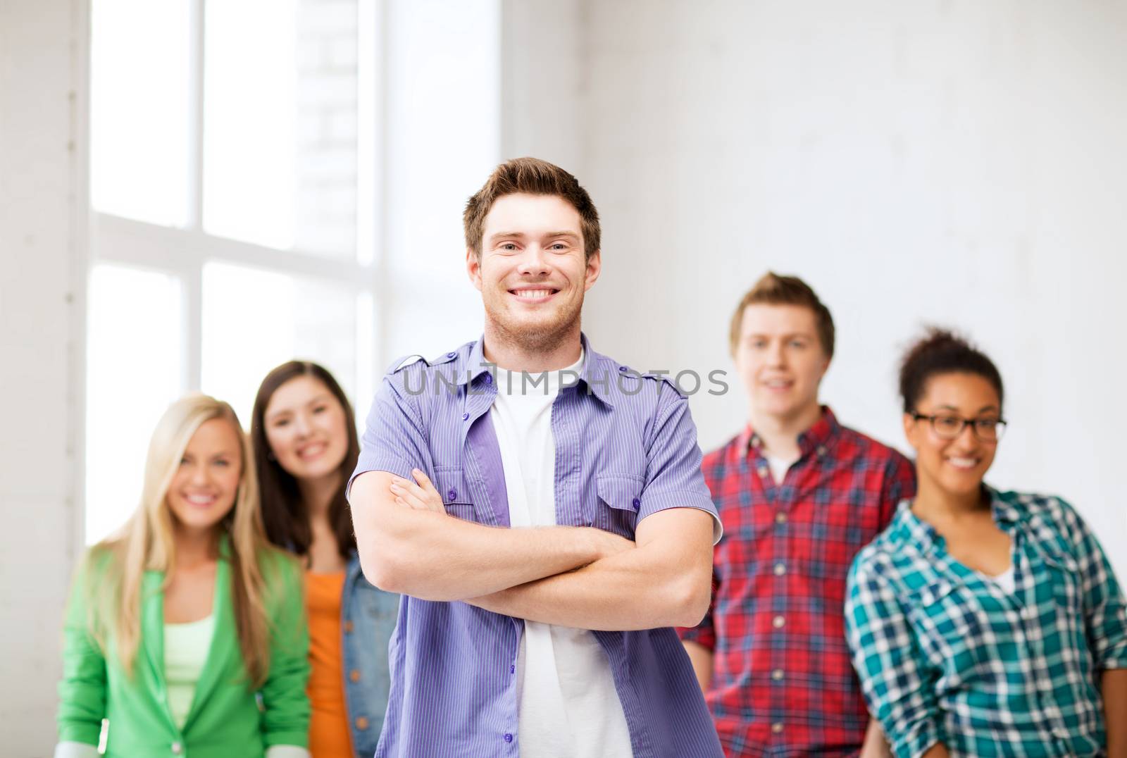 education concept - student boy with group of students at school