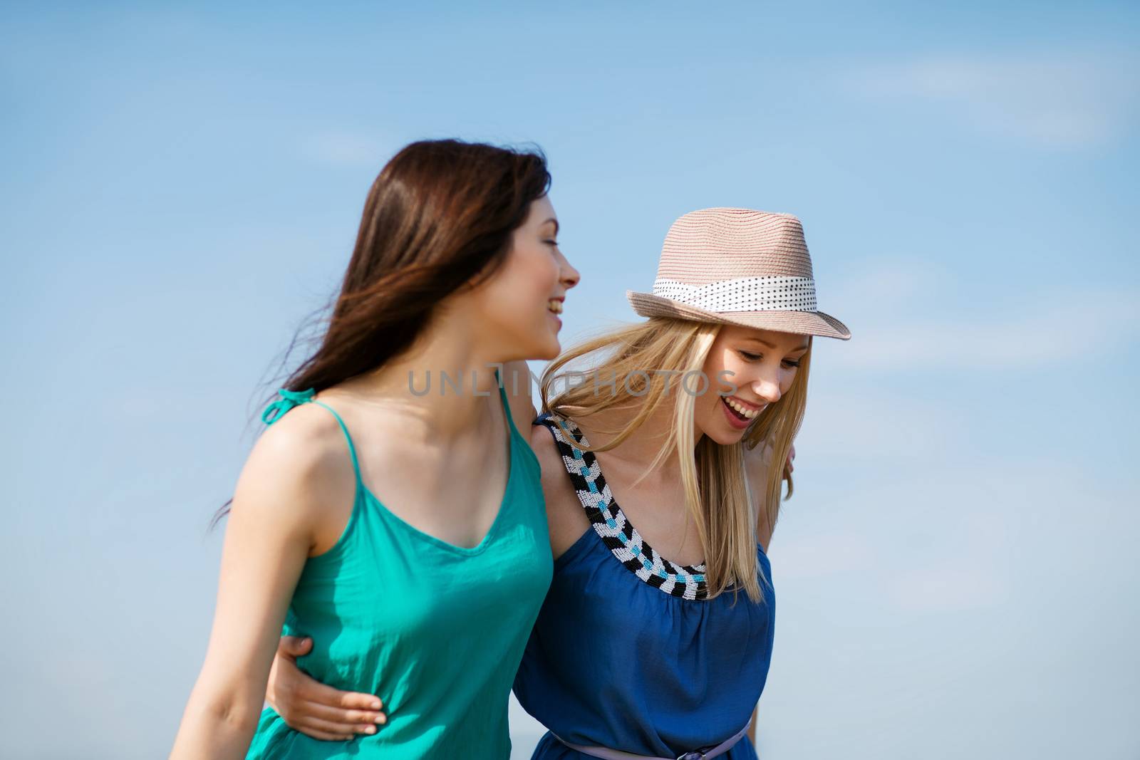 girls walking on the beach by dolgachov