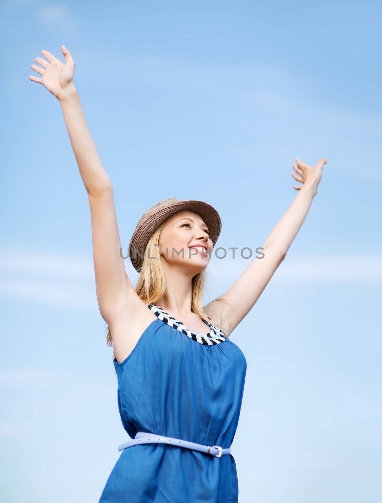 girl with hands up on the beach by dolgachov