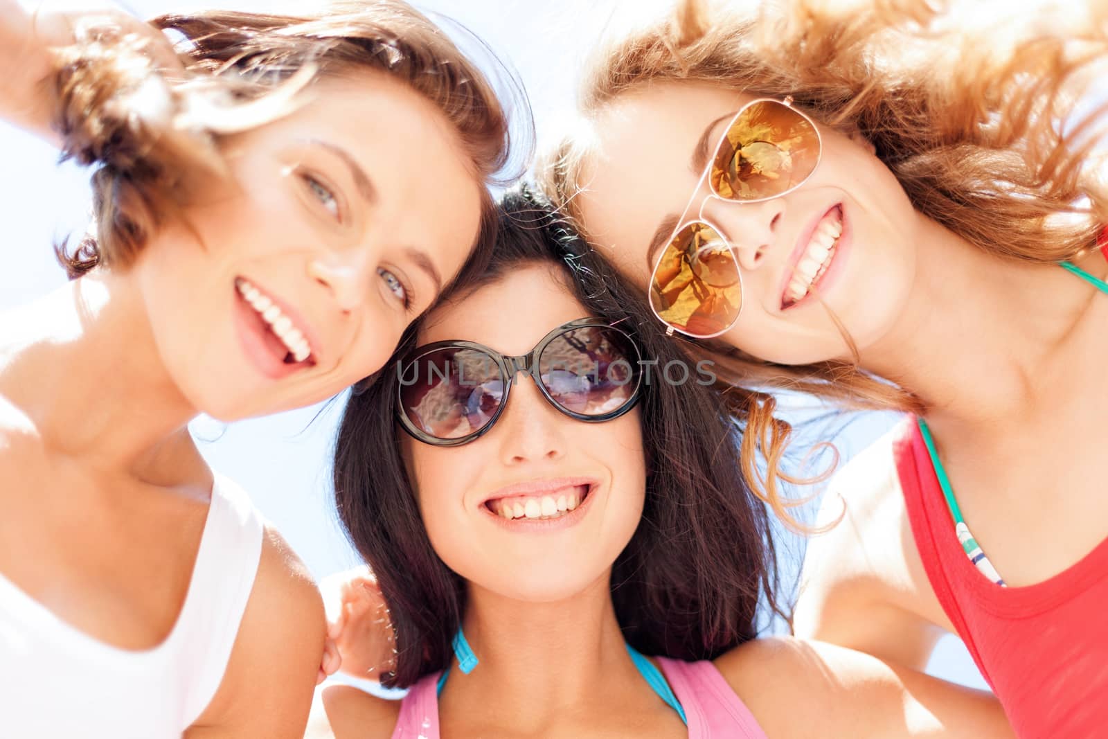 girls faces with shades looking down by dolgachov