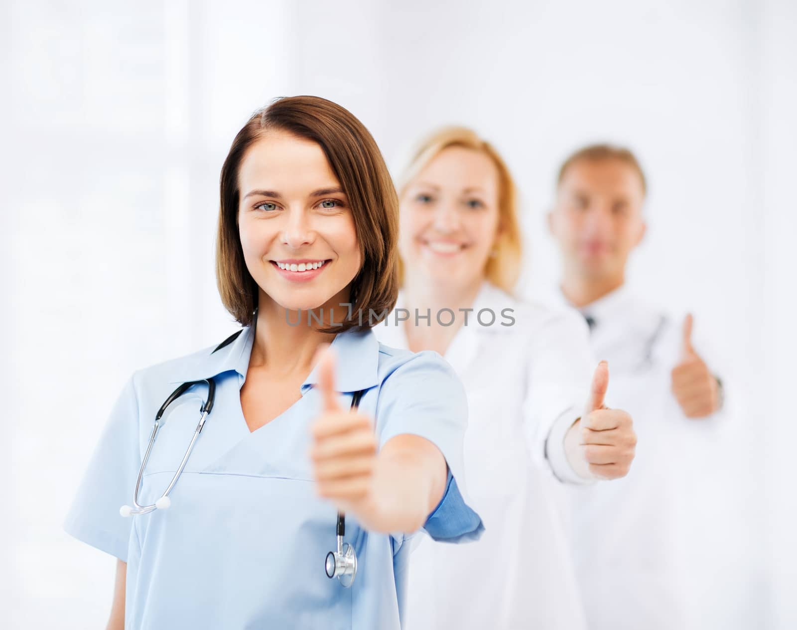 team of doctors showing thumbs up by dolgachov