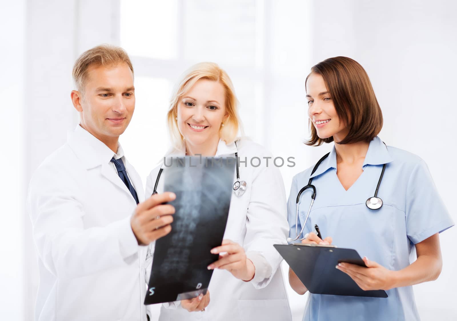 healthcare, medical and radiology concept - doctors looking at x-ray