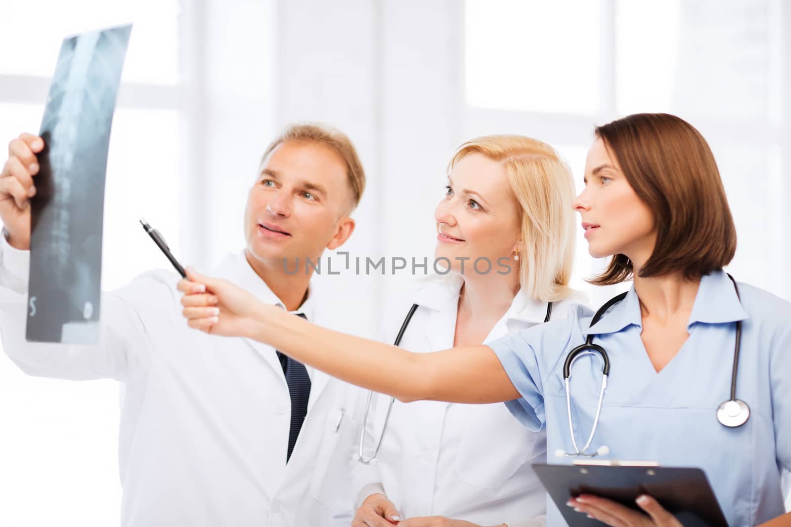 healthcare, medical and radiology concept - doctors looking at x-ray