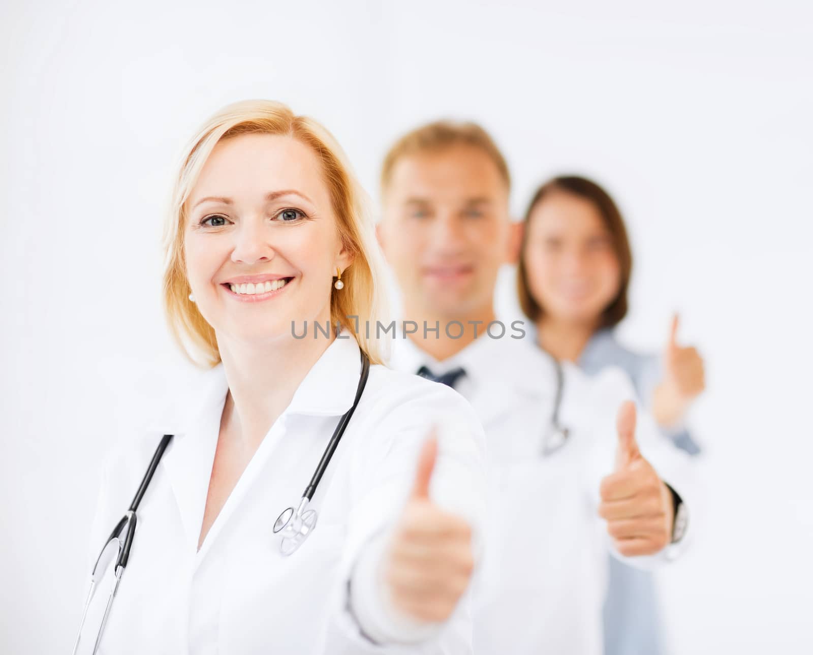 team of doctors showing thumbs up by dolgachov