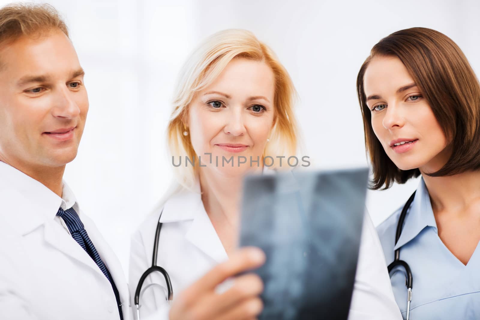 doctors looking at x-ray by dolgachov