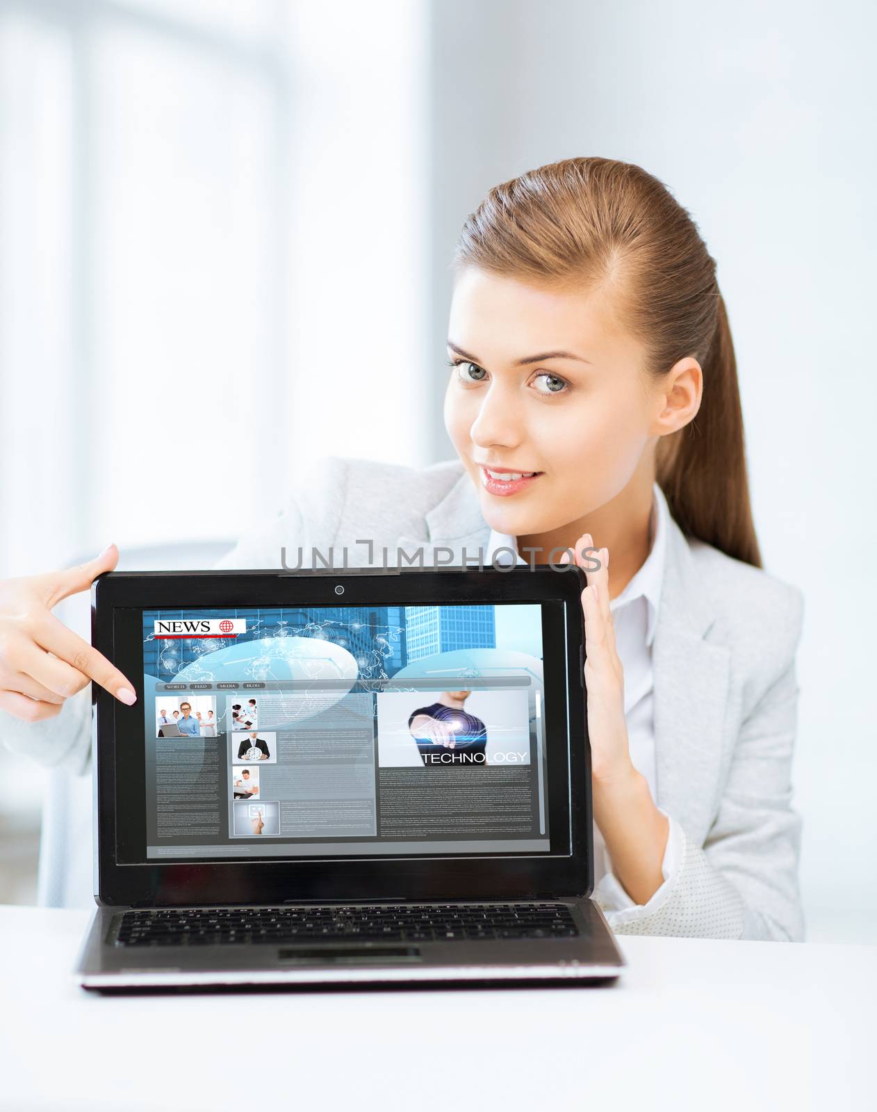 woman showing laptop pc with news by dolgachov