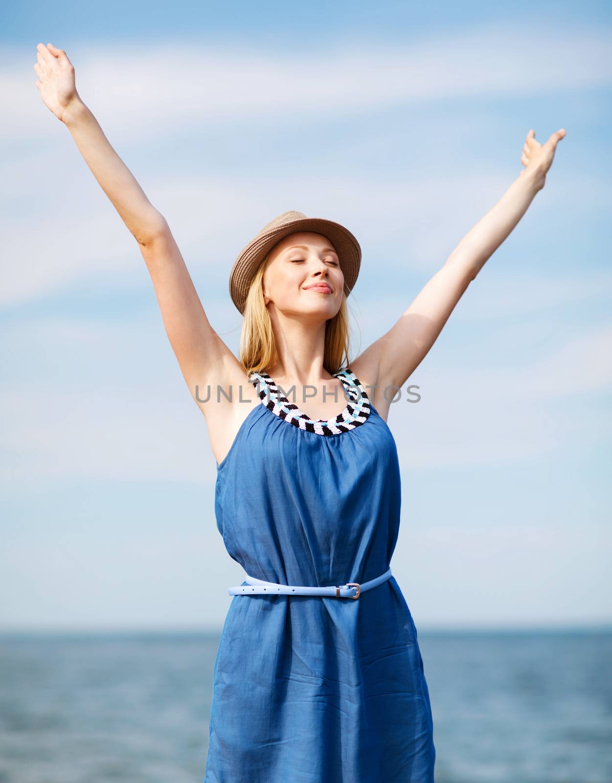 girl with hands up on the beach by dolgachov