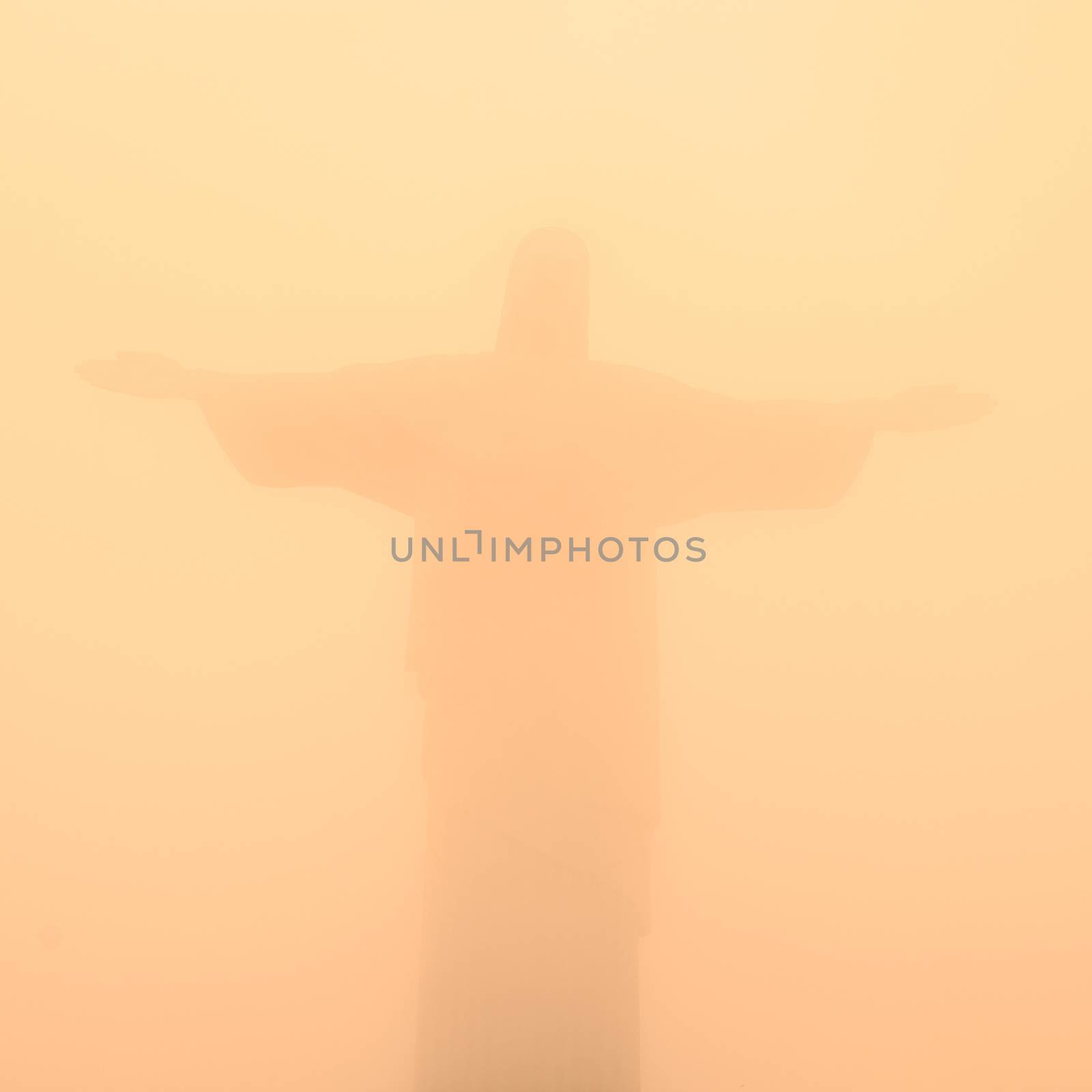 Christ the Redeemer Statue in misty sunset, Rio de Janeiro, Brazil.