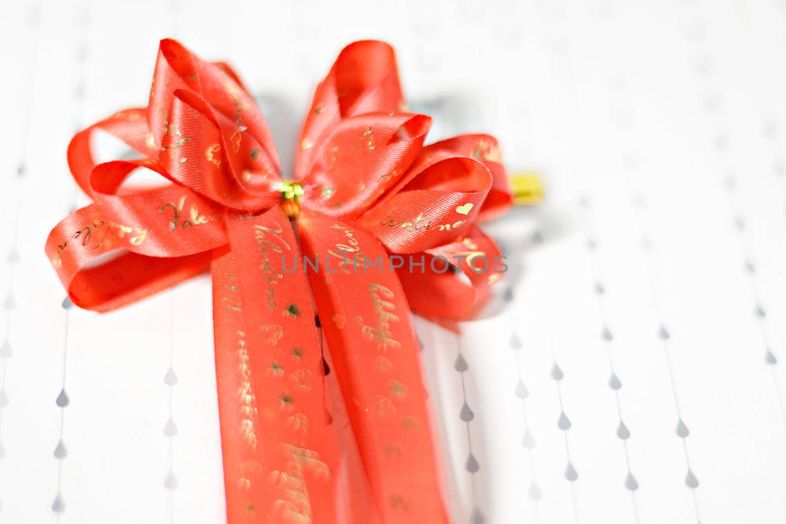 Decoration red glossy ribbon bow on ribbon print word valentine by Yuri2012