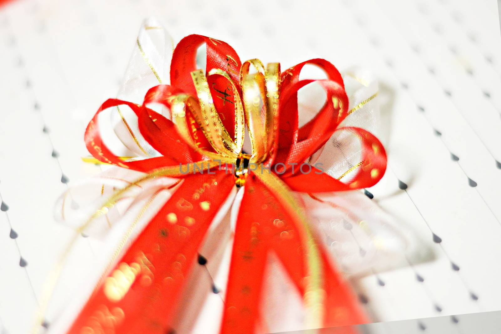 Decoration red glossy ribbon bow on ribbon print word valentine by Yuri2012