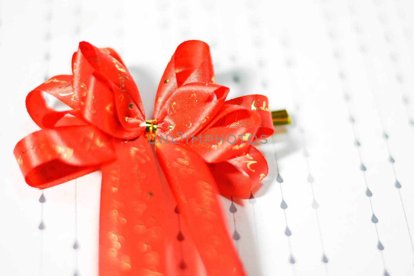 Decoration red glossy ribbon bow on ribbon print word valentine by Yuri2012