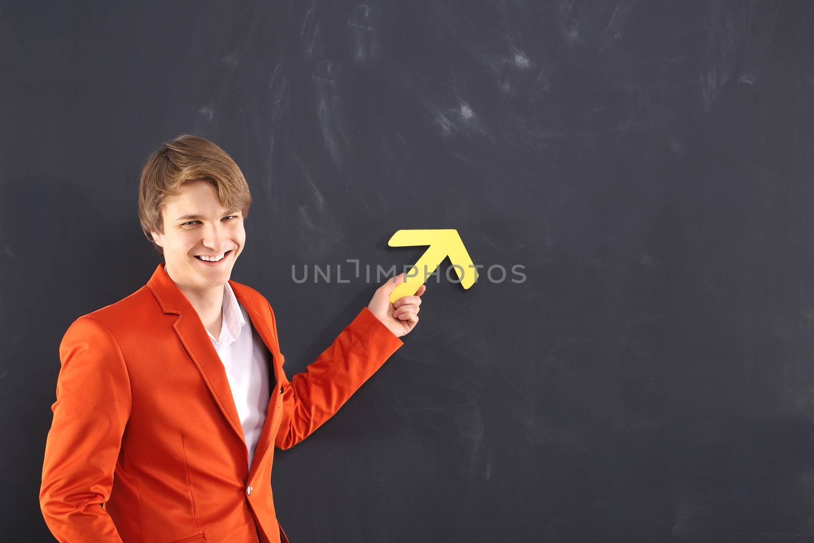 Happy man pointing at the black board by robert_przybysz